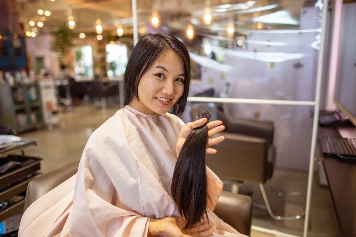 Woman holding her hair after hair donation