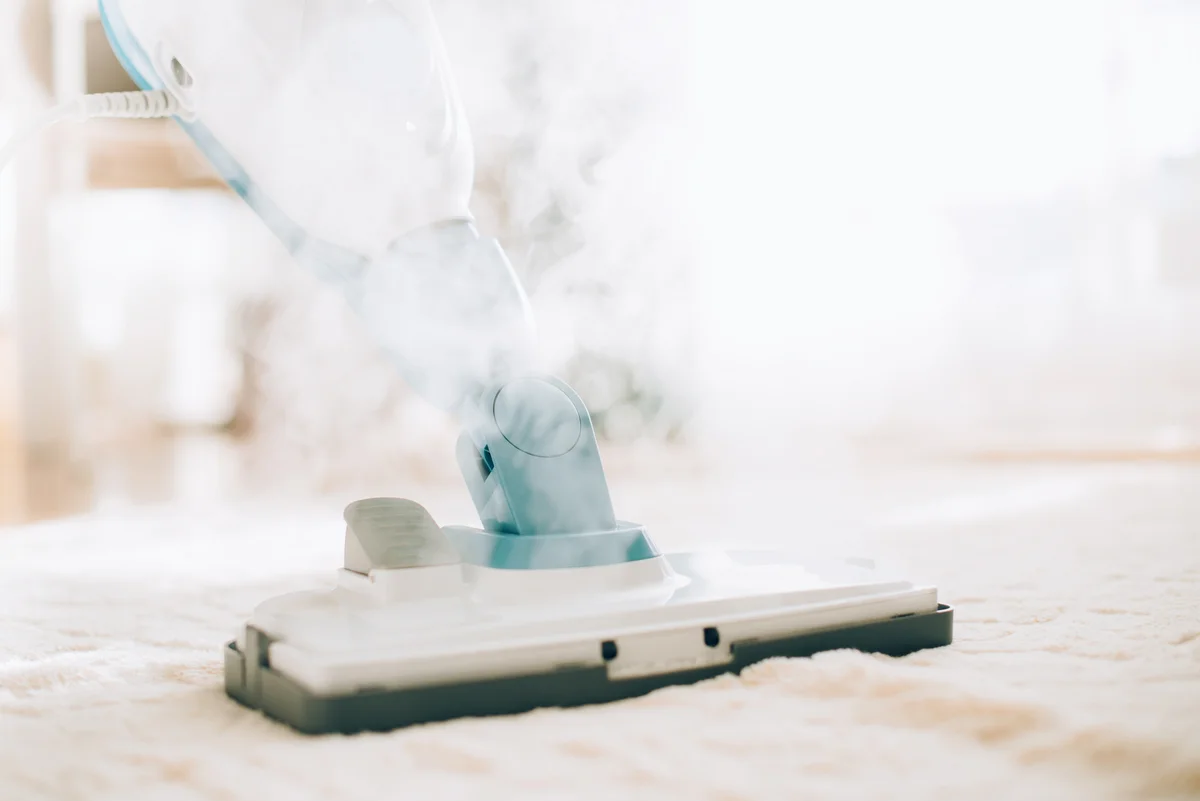 Cleaning the floor with steam cleaner