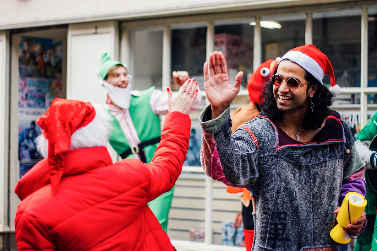 Christmas charity buskers are high fiving in the street as they raise money for charity