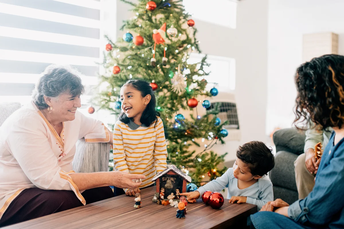 Children preparing Nativity with Grandmother