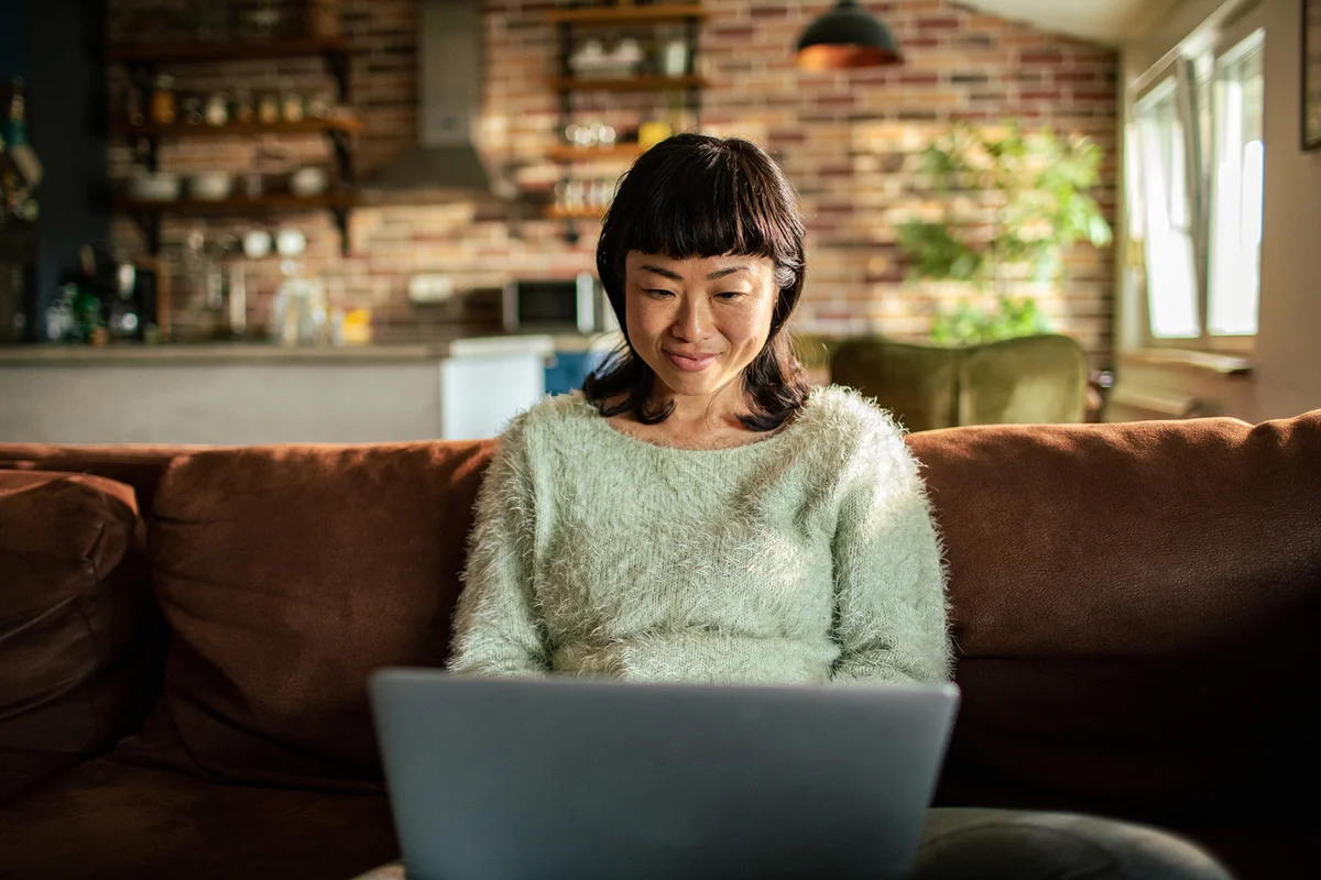 Woman using a laptop on a couch