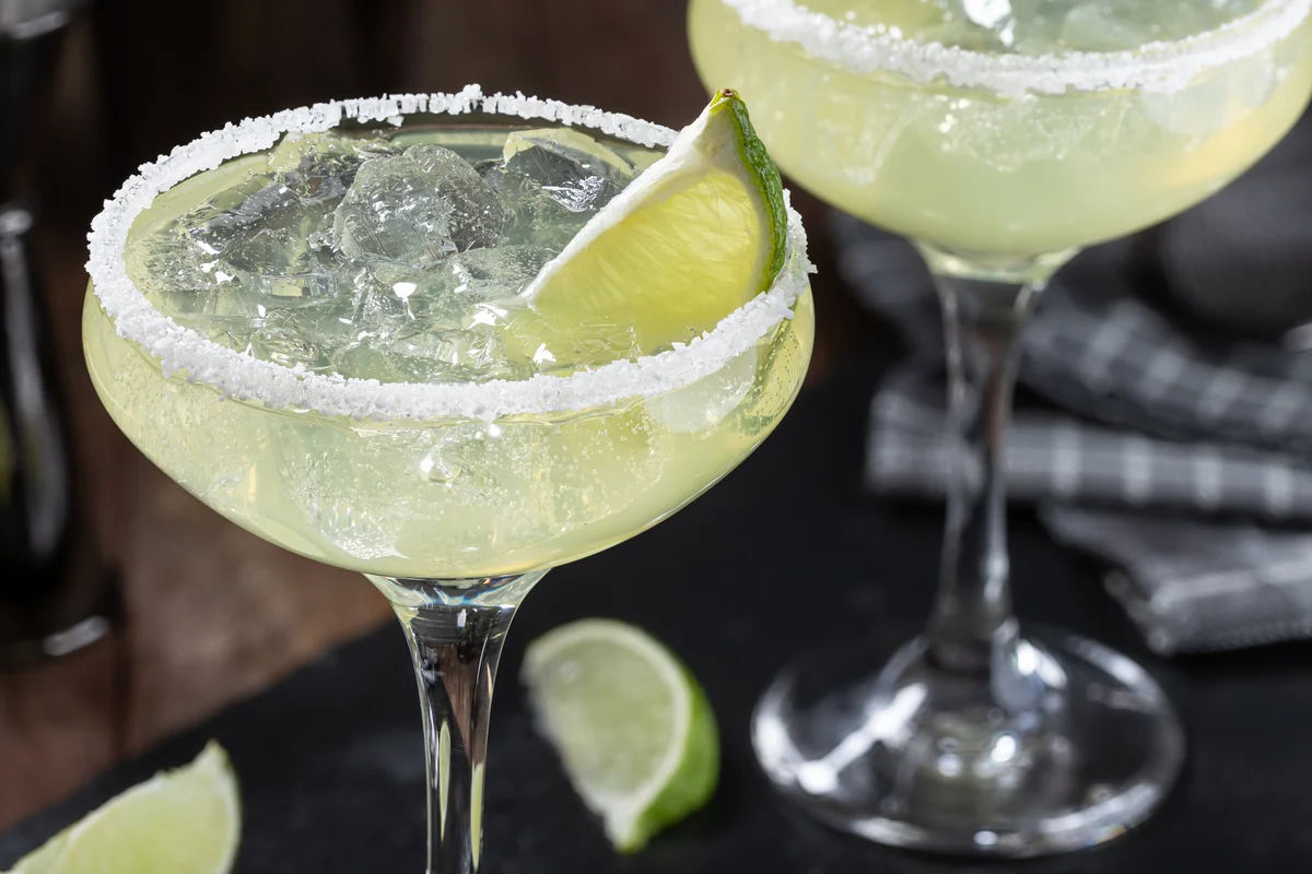 Margarita cocktail with ice, lime and salt rim