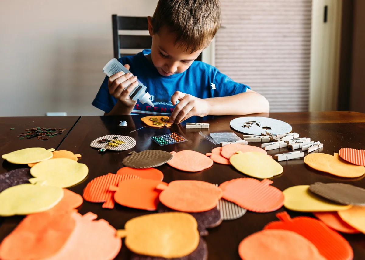 Boy making apples shape art at home