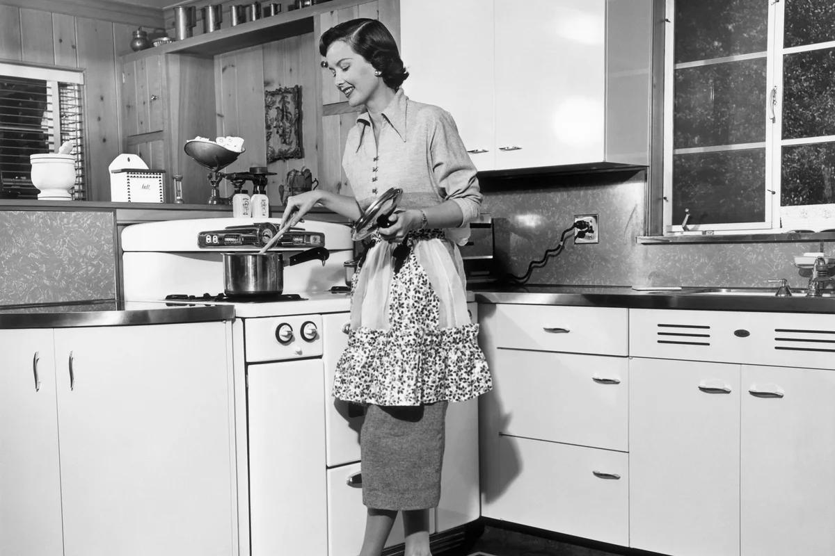 50's Housewife stirring pot at stove
