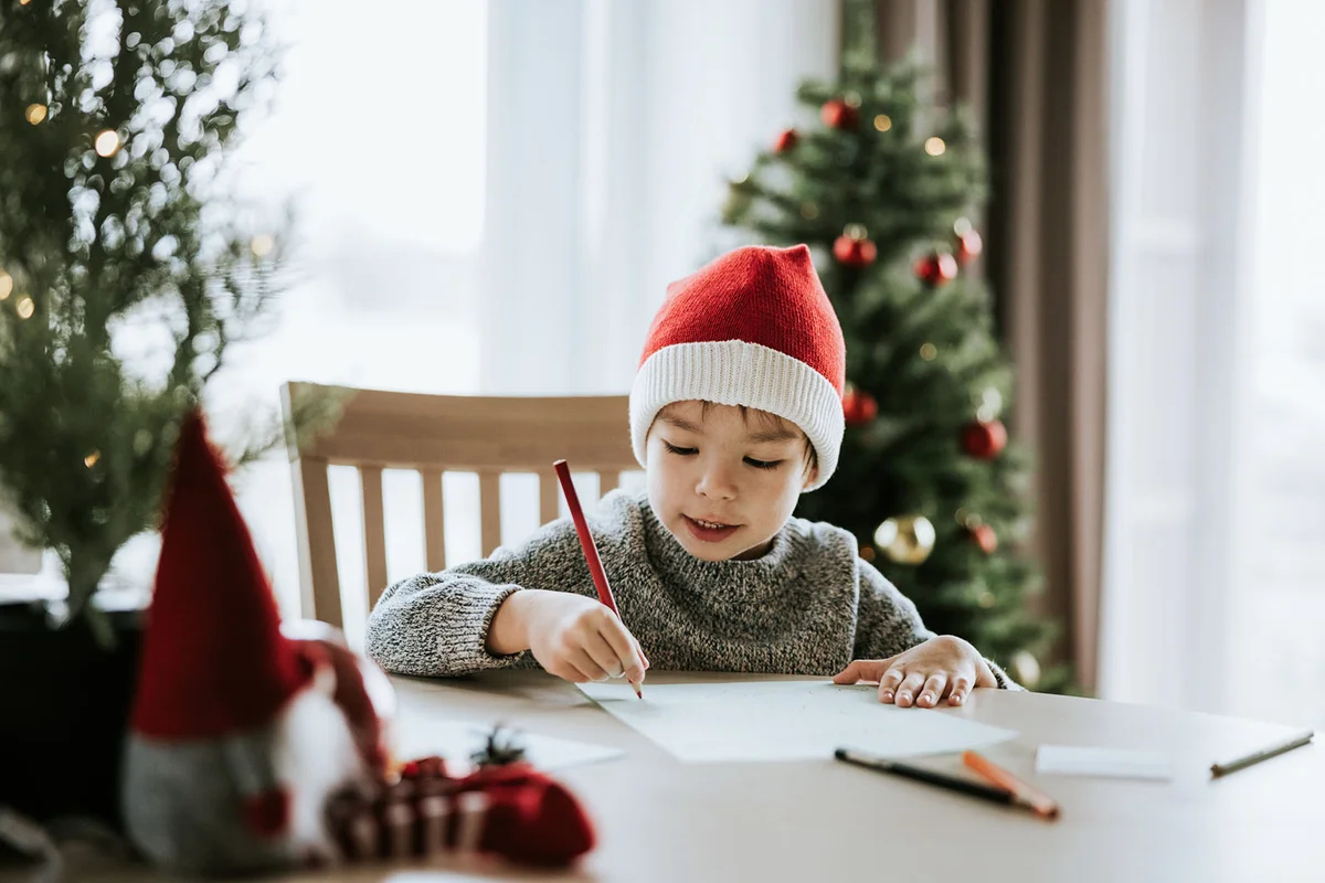 Boy writes a letter to Santa Clause