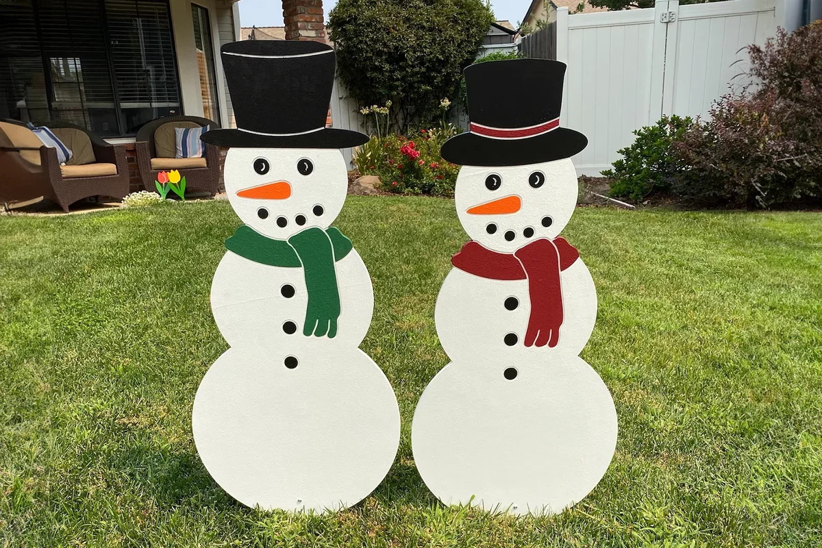 Snow Couple Wearing A Hat And Scarf Outdoor Christmas Holiday