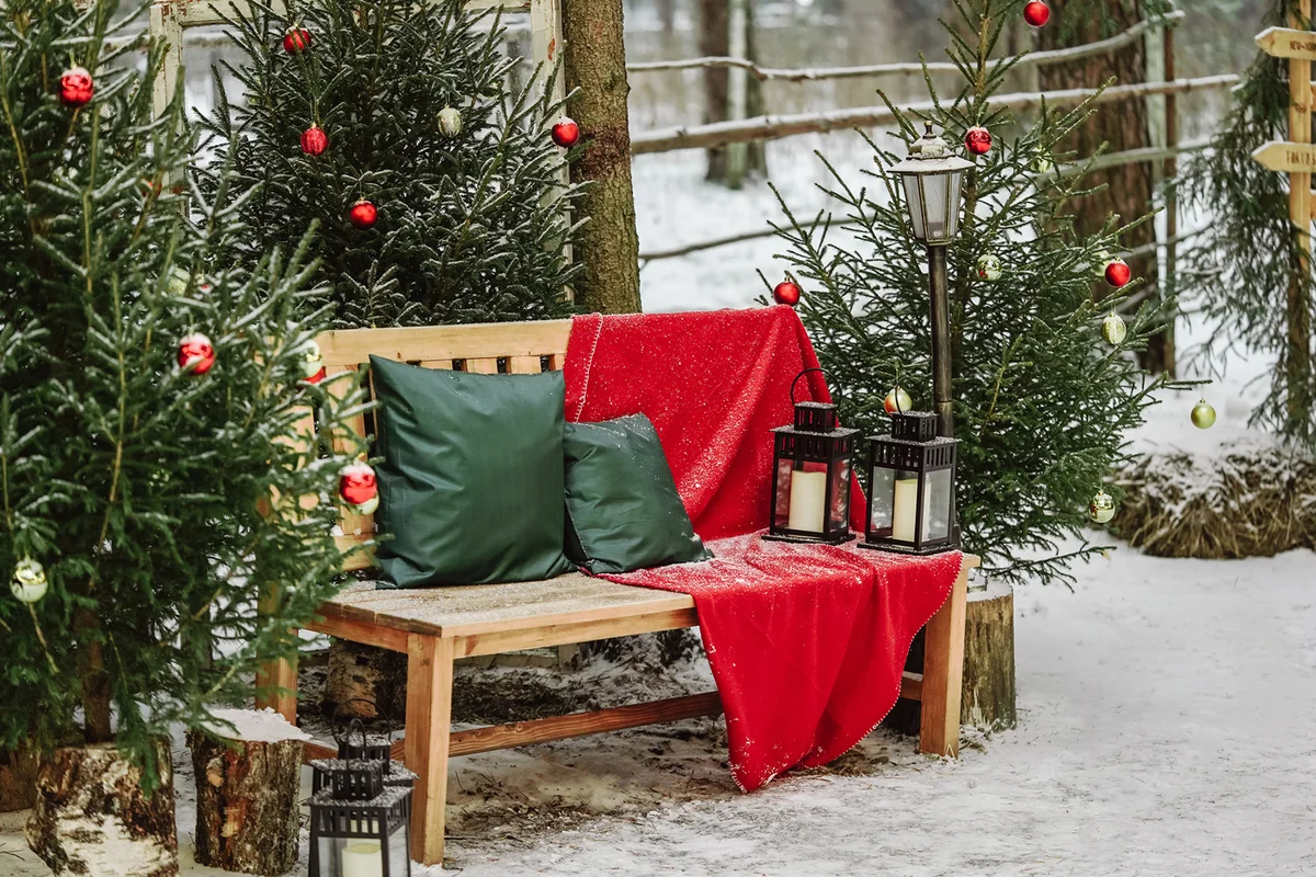 New Year's photo zone with decorated Christmas trees and bench