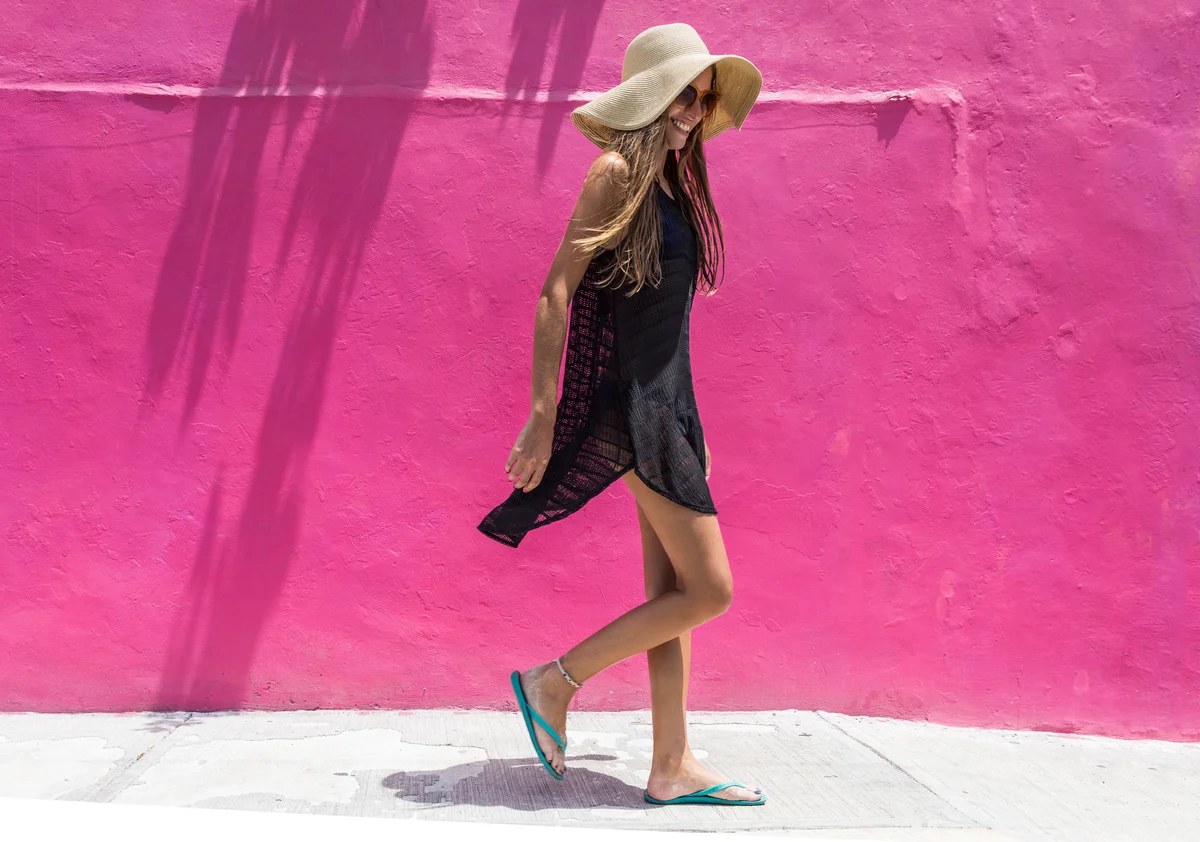 woman in sun hat and flip flops
