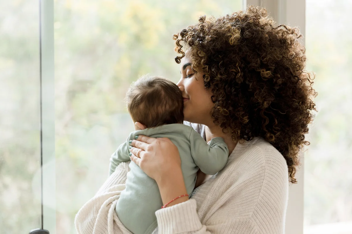 Young mom smells her baby's head