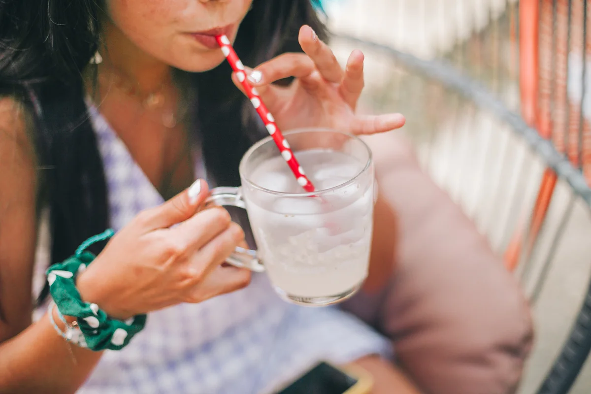 woman sipping a mocktail