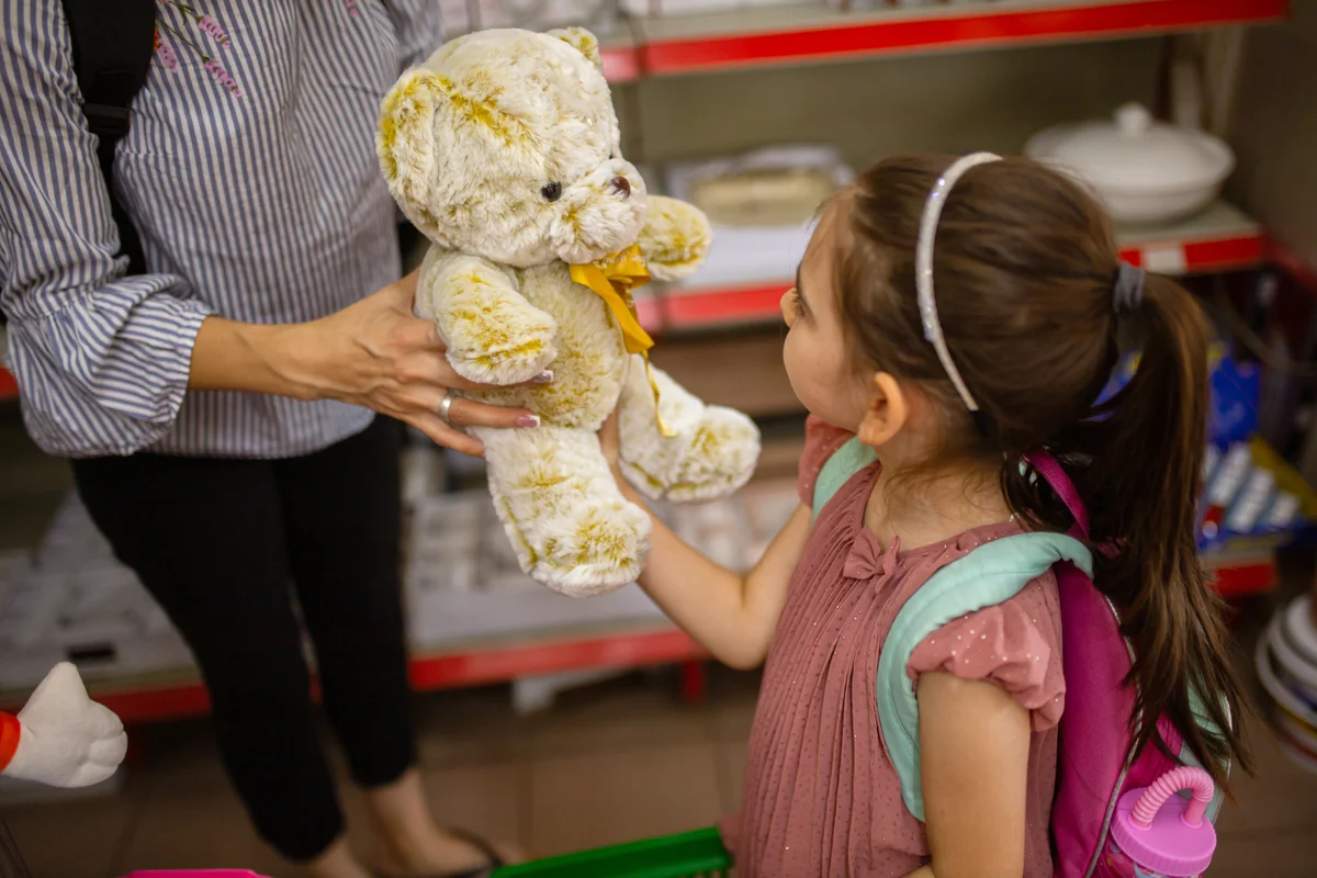 giving a stuffed bear