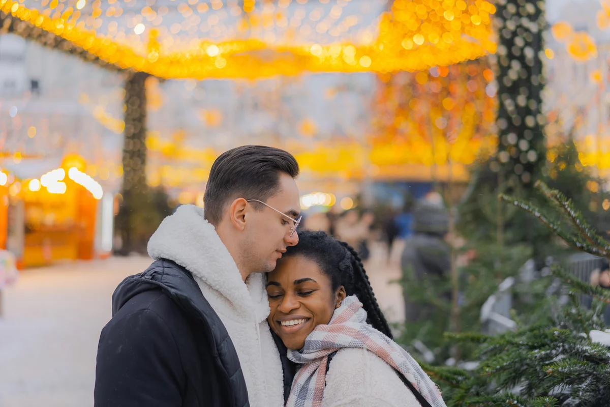 Couple embracing on the background of Christmas tree