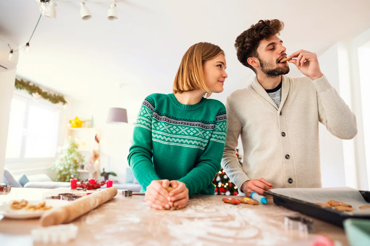 Young couple making Christmas cookies