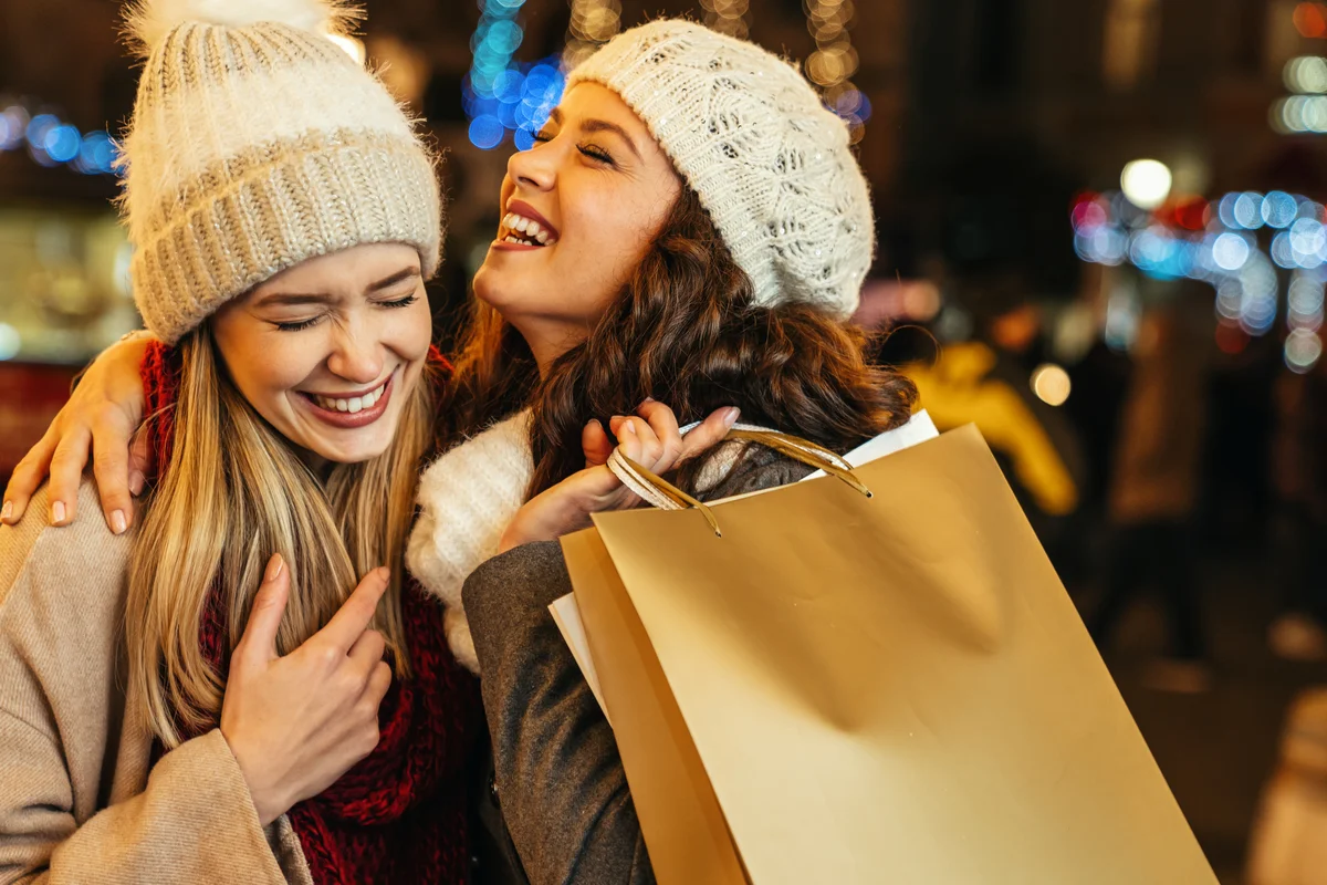 women enjoying shopping together outdoors