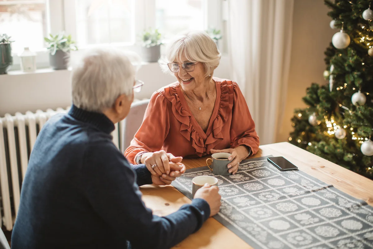 Senior couple drinking coffee for Christmas at home