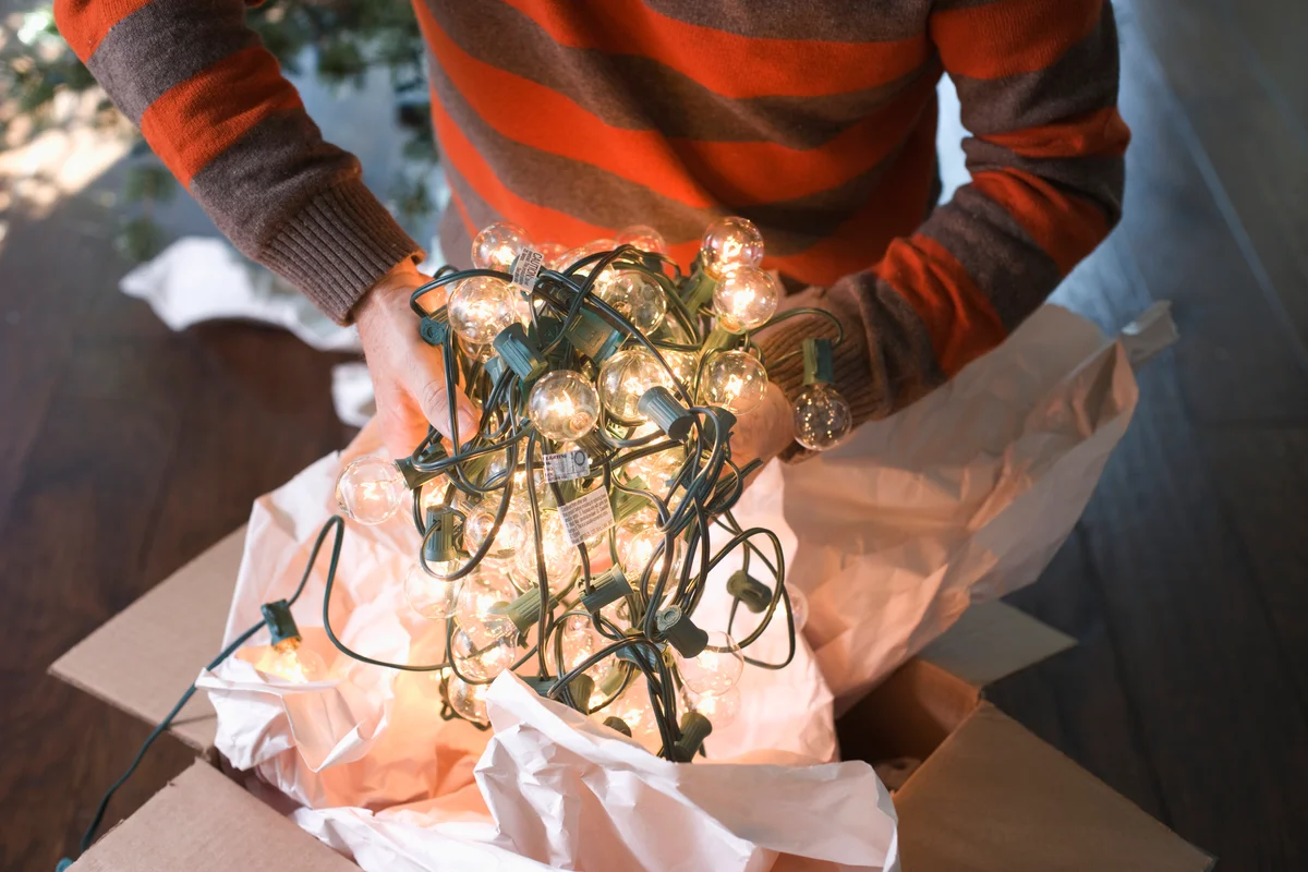 Man holding christmas lights