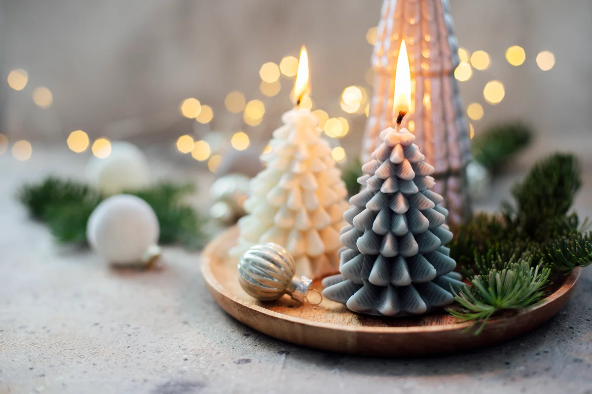 Wooden tray with burning candles shape of Christmas tree