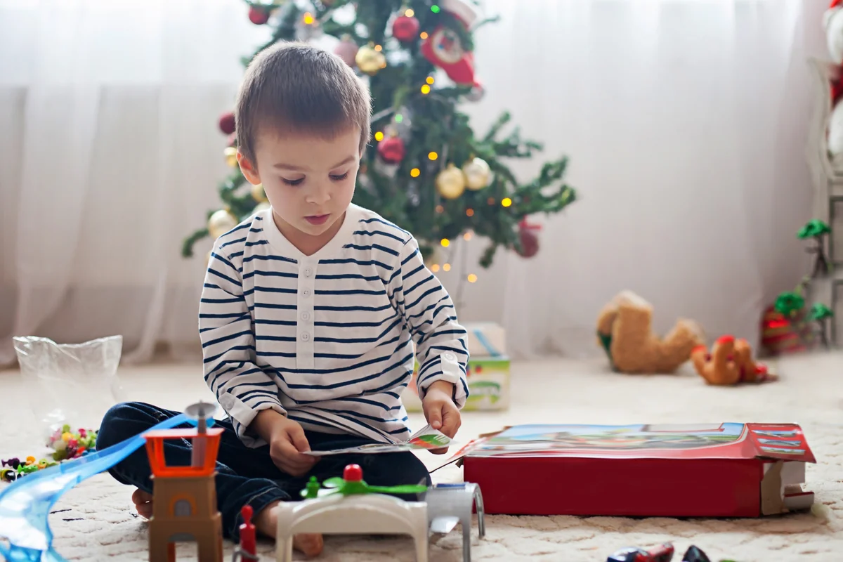 Cute little boy, playing with toys at Christmas