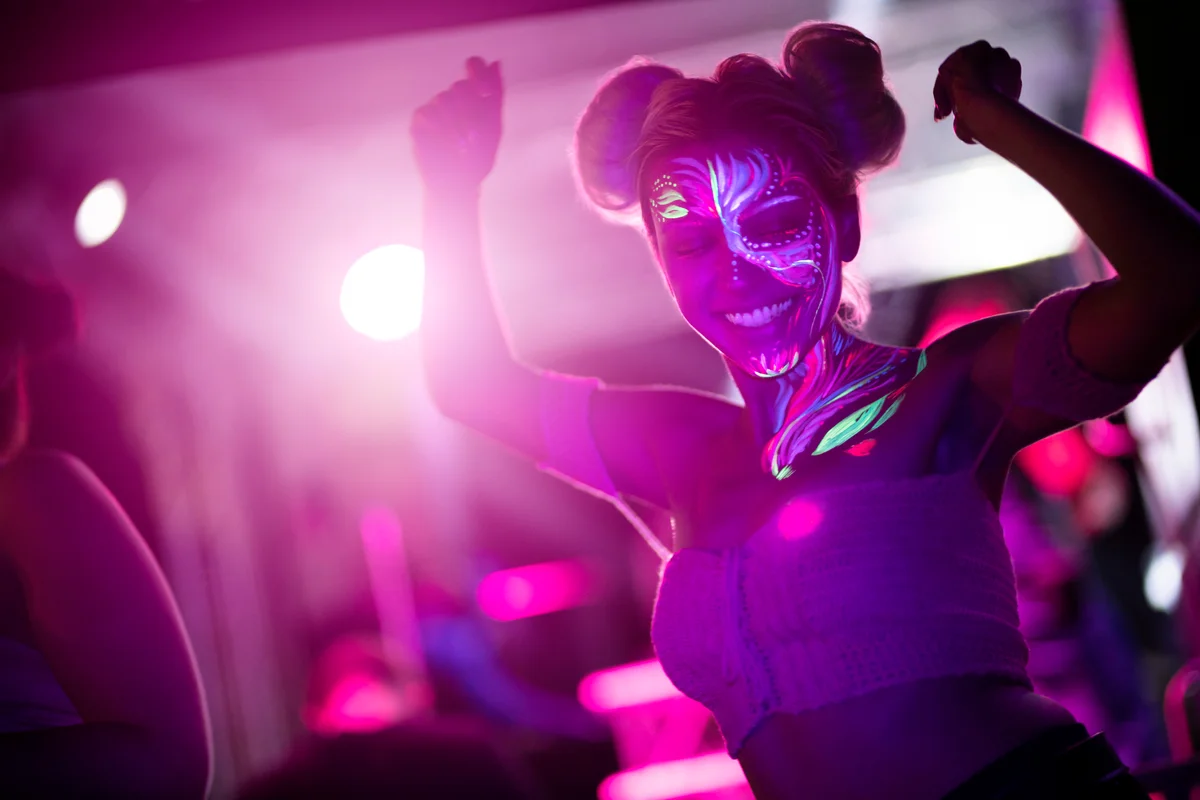 Girl with fluorescent body paint dancing