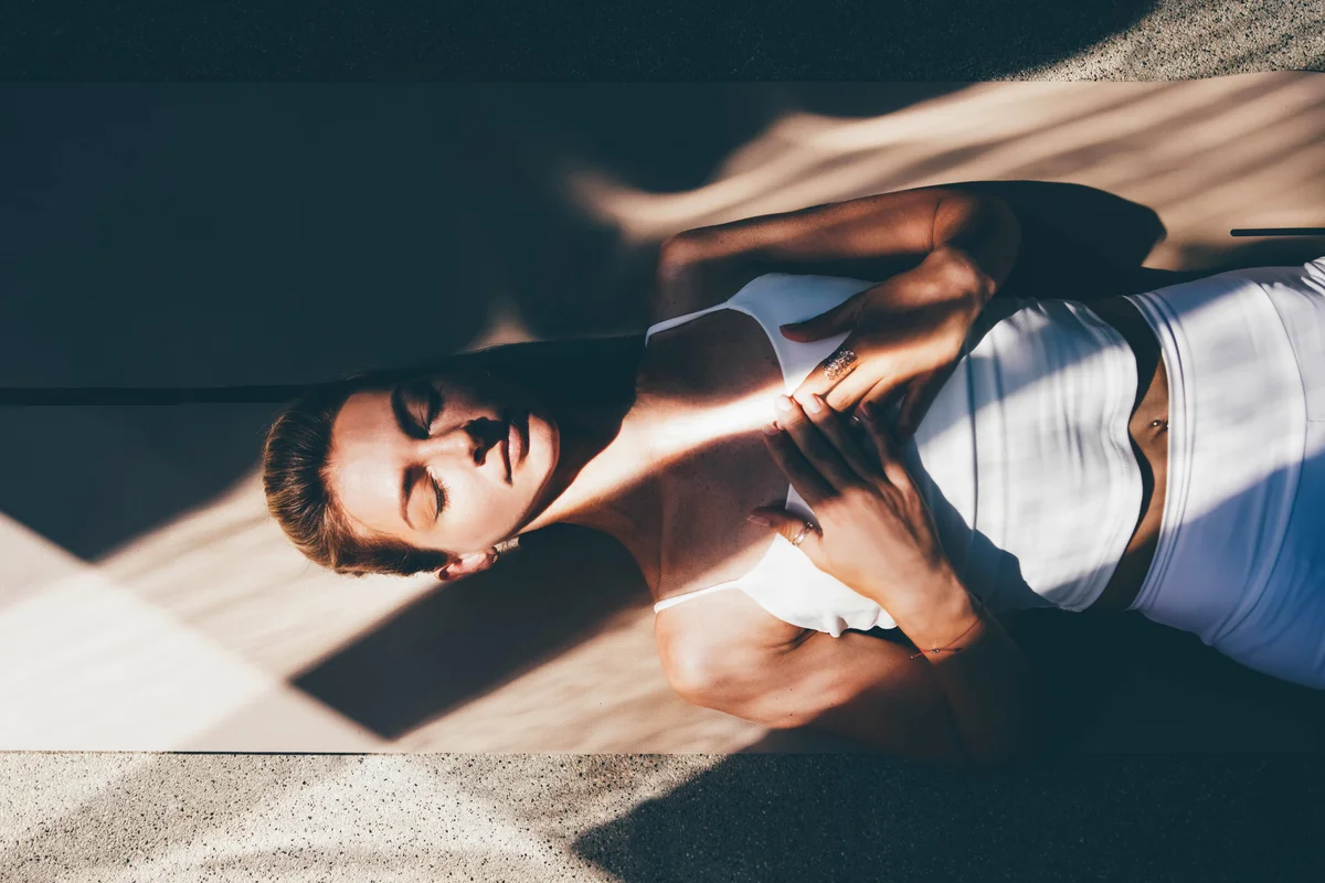 Woman lying on floor meditating