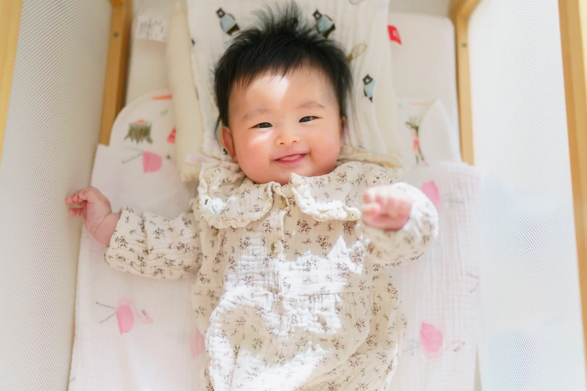 Small baby looking at the camera and smiling