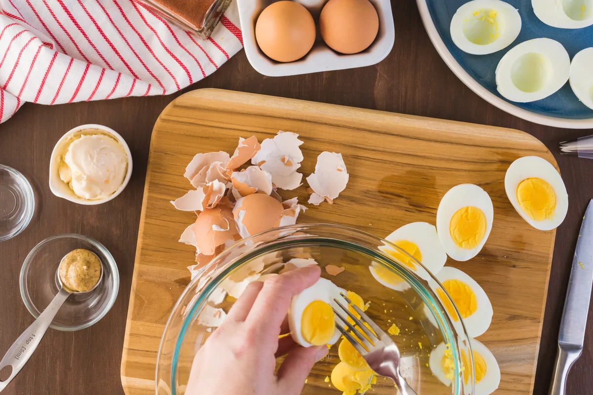 preparing deviled egg filling