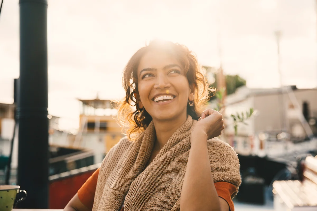 woman by houseboats on a sunny day