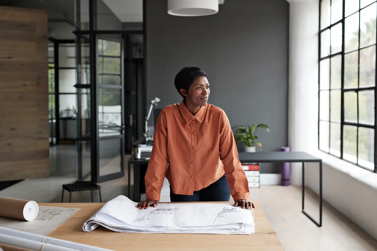woman looking at blueprints