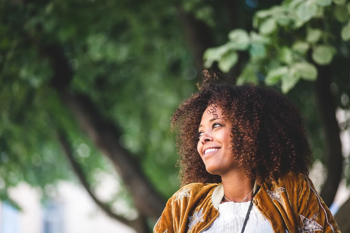 woman in a park, smiling