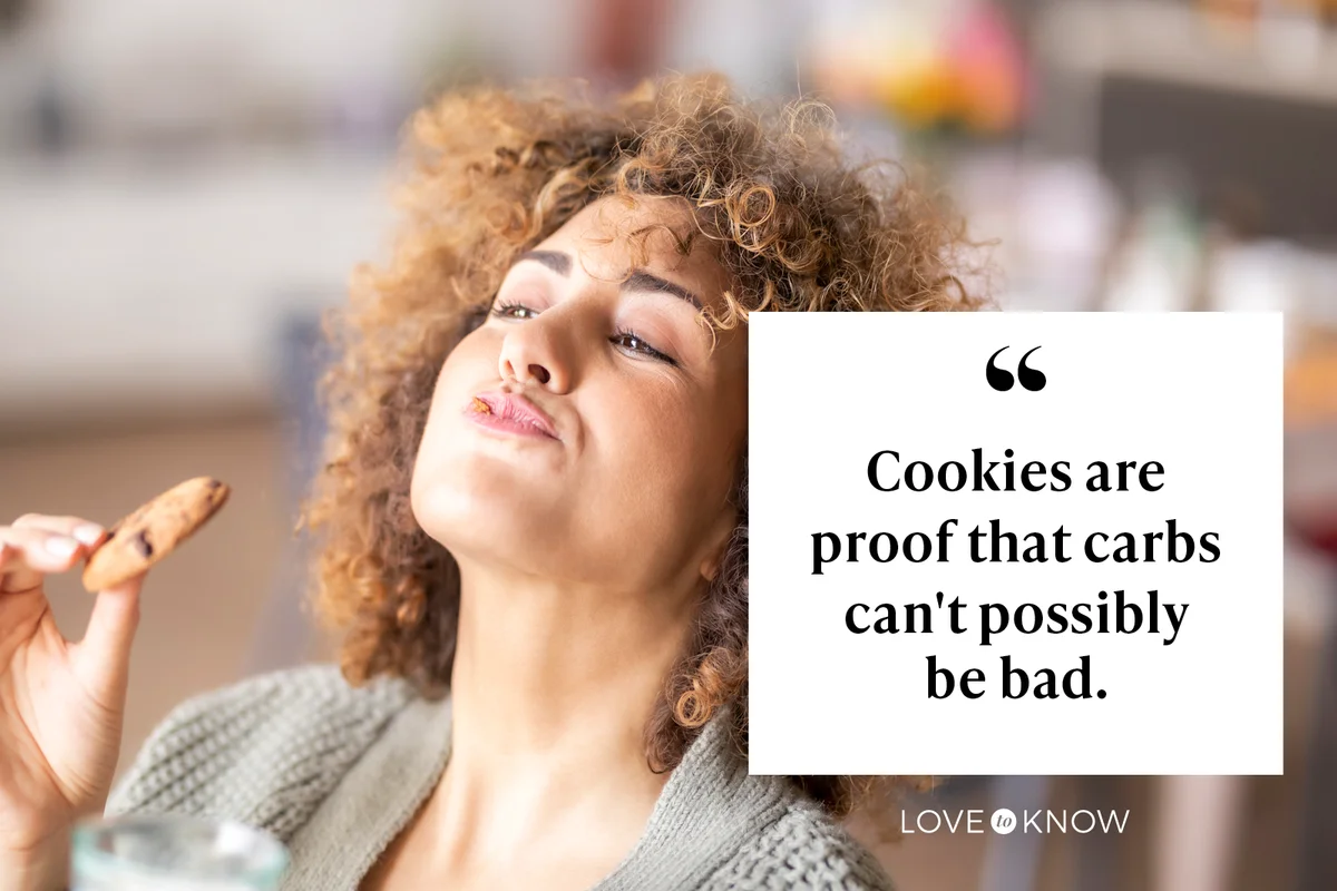 Woman smiling and eating a cookie