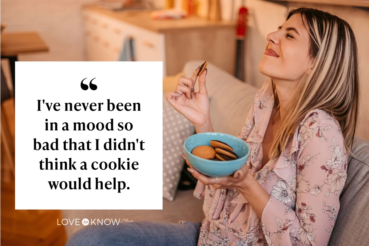 Woman sitting on sofa in living room and eating cookies