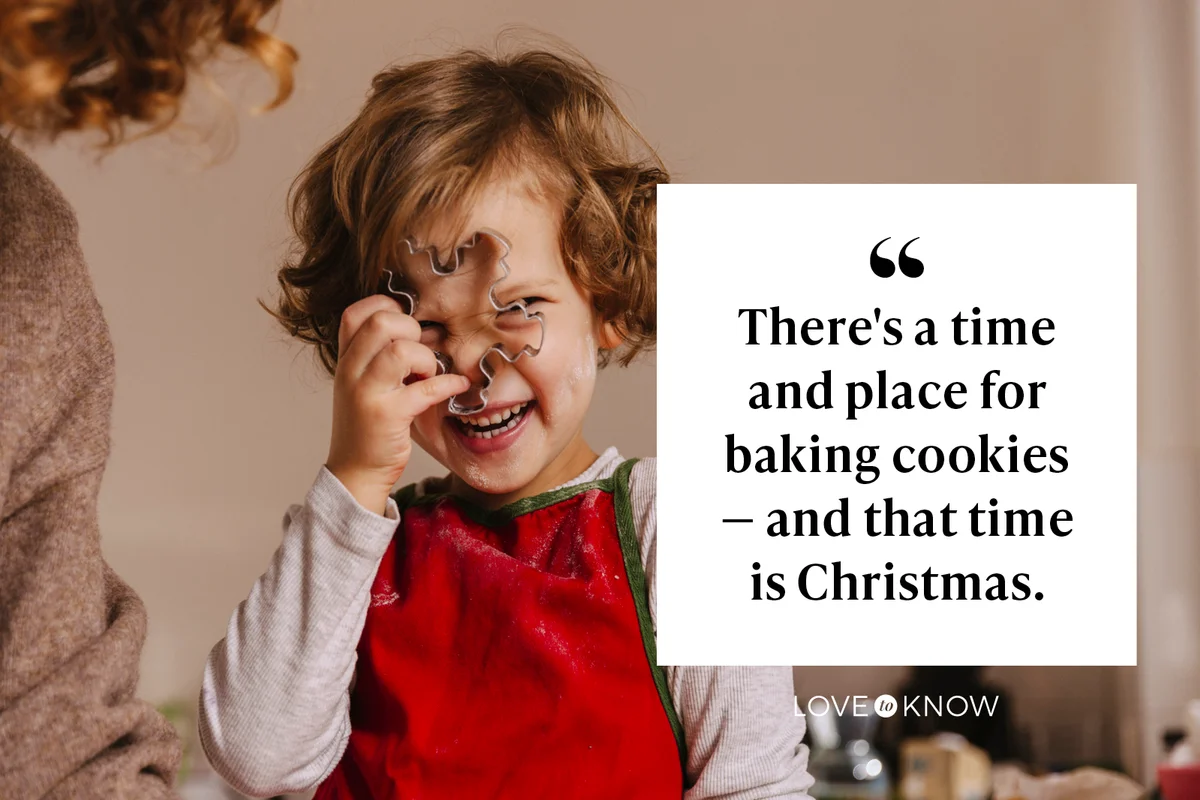 Playful girl with her mother holding Christmas cookie cutter