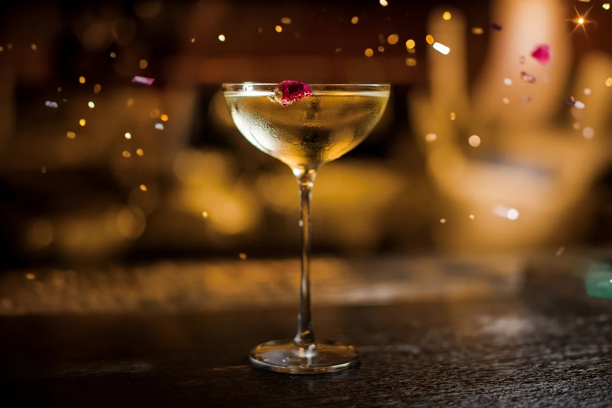 One glass of Twinkle cocktail decorated with one red berry