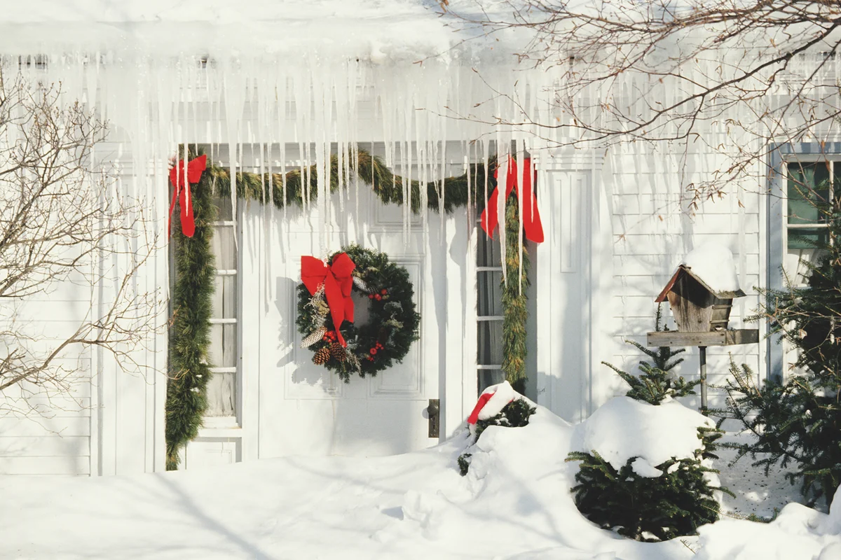 Christmas decorations and icicles by front door of house