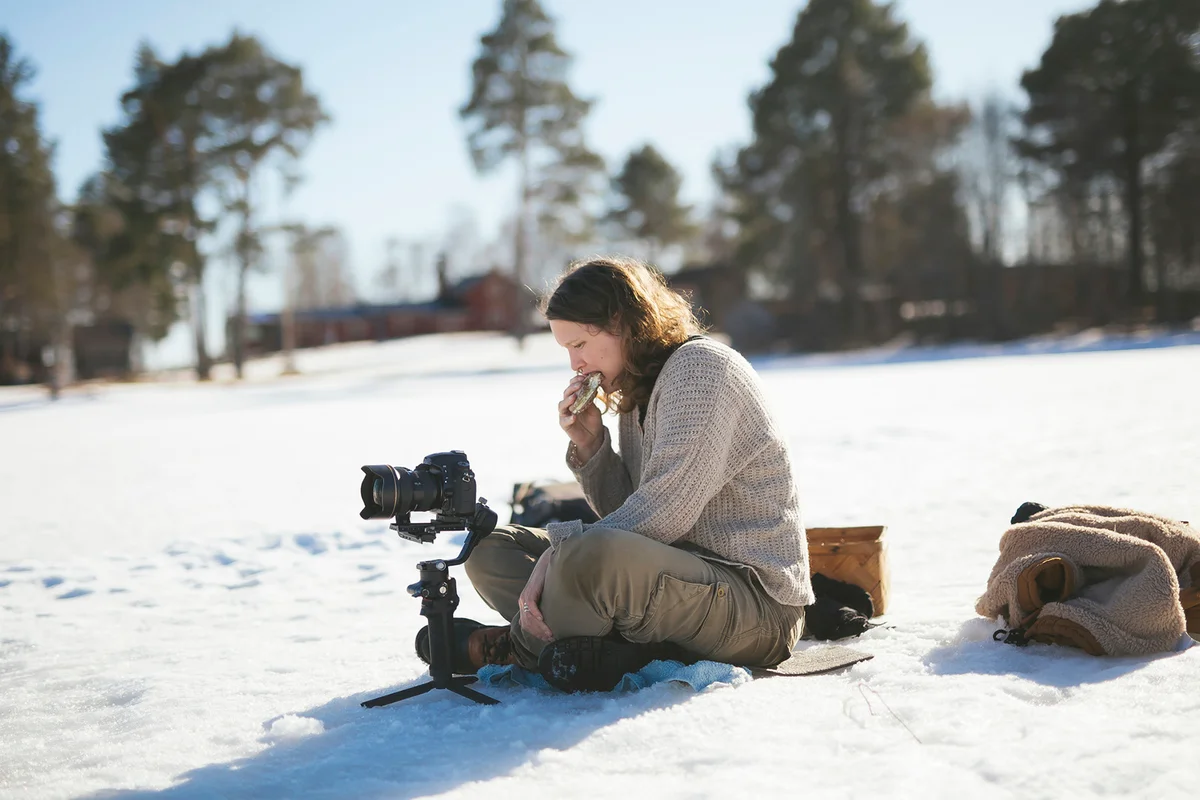 Photographer sitting on snow and relaxing