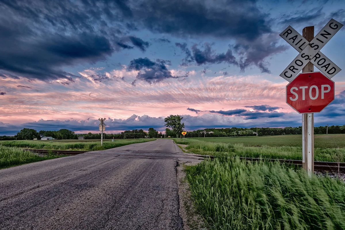 Rural railway crossing with dramatic weather
