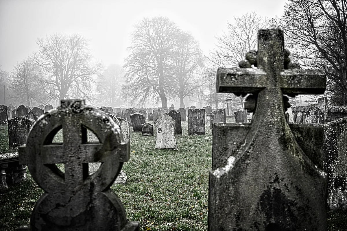 Foggy view of gravestones in old cemetery