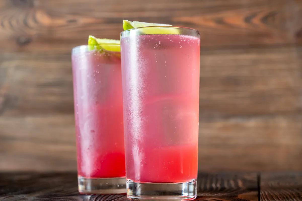 Two El Diabo Cocktails garnished with lime wedges