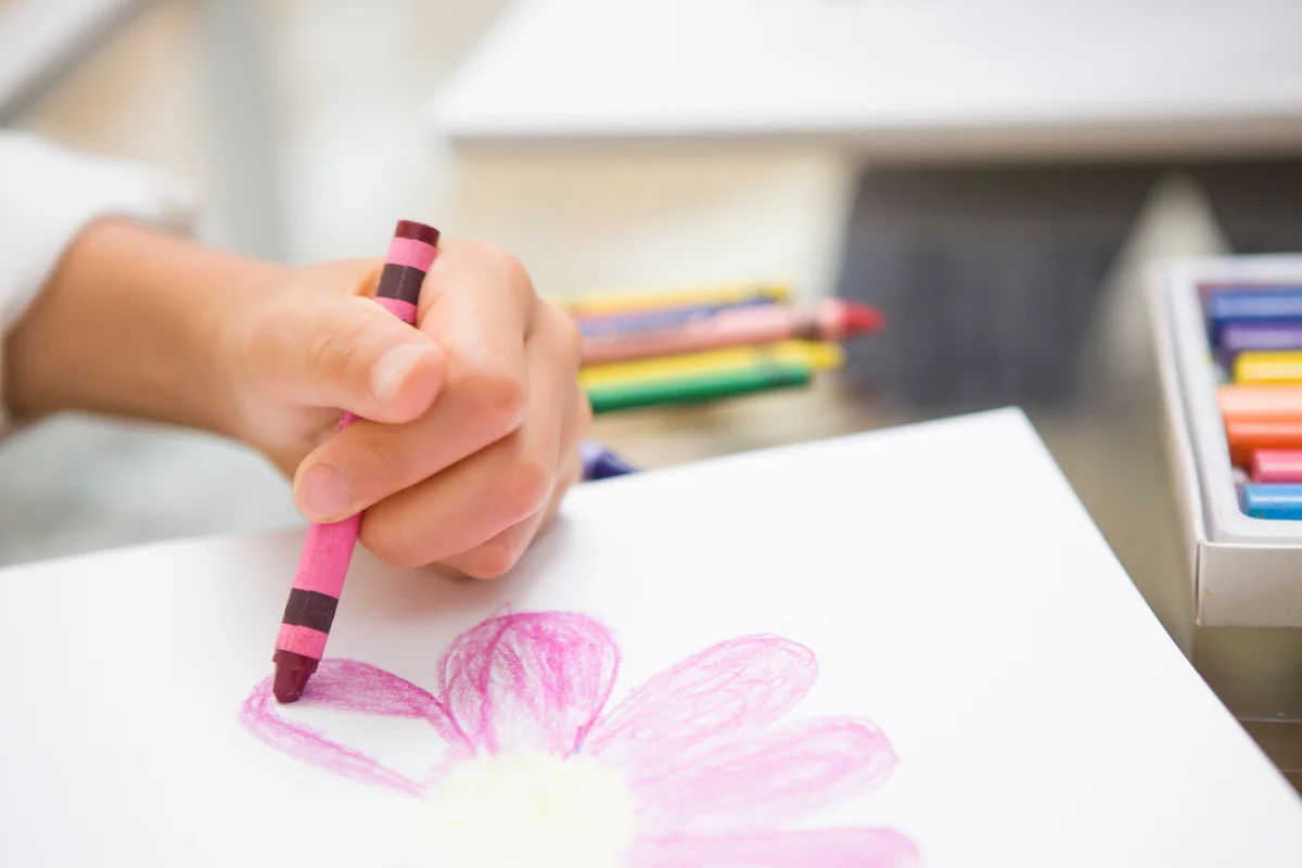 Toddler painting with crayon