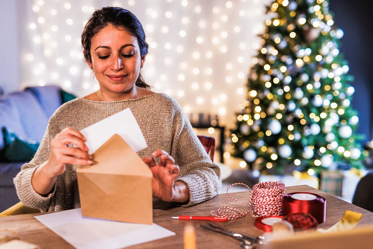 Woman putting a Christmas letter