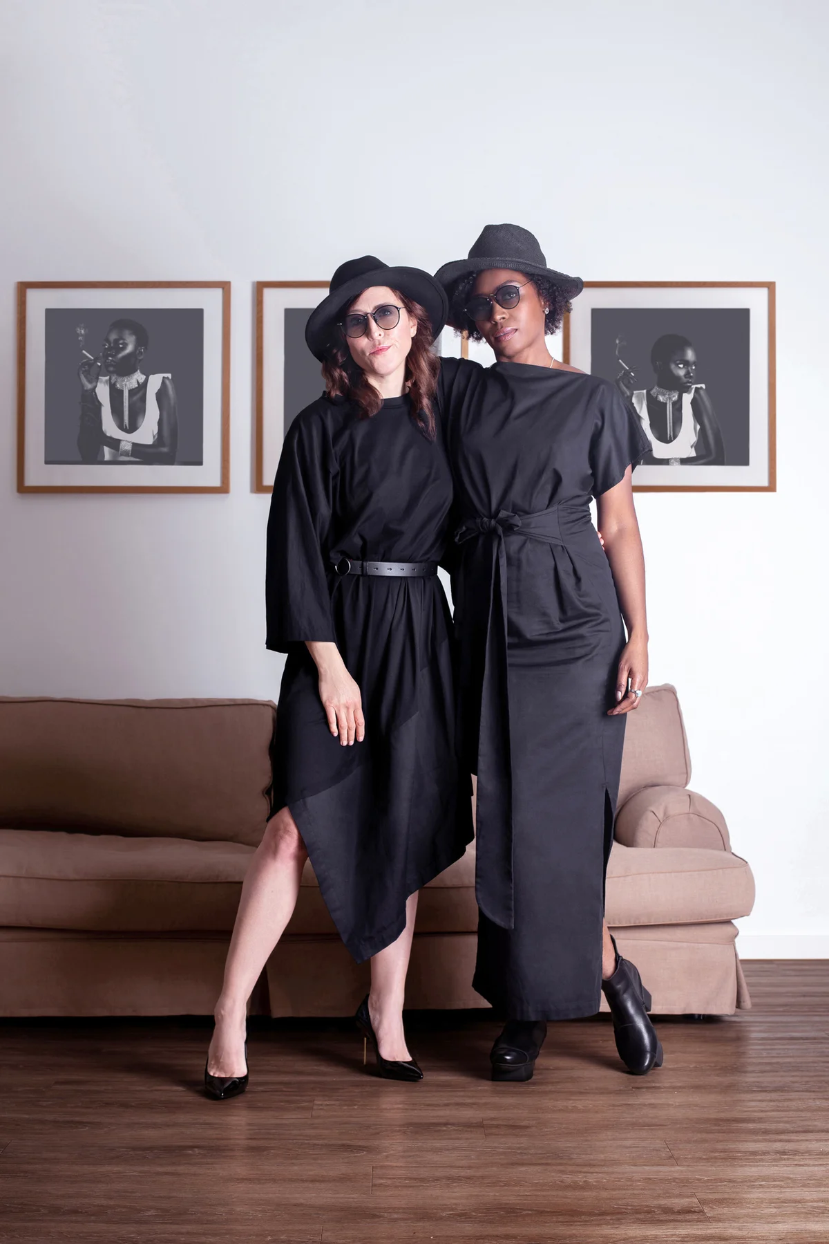 Women wearing black dresses and fedoras