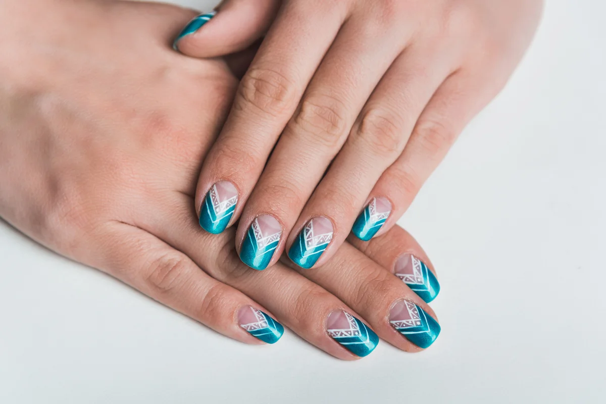 Nail art with bright blue chevron pattern