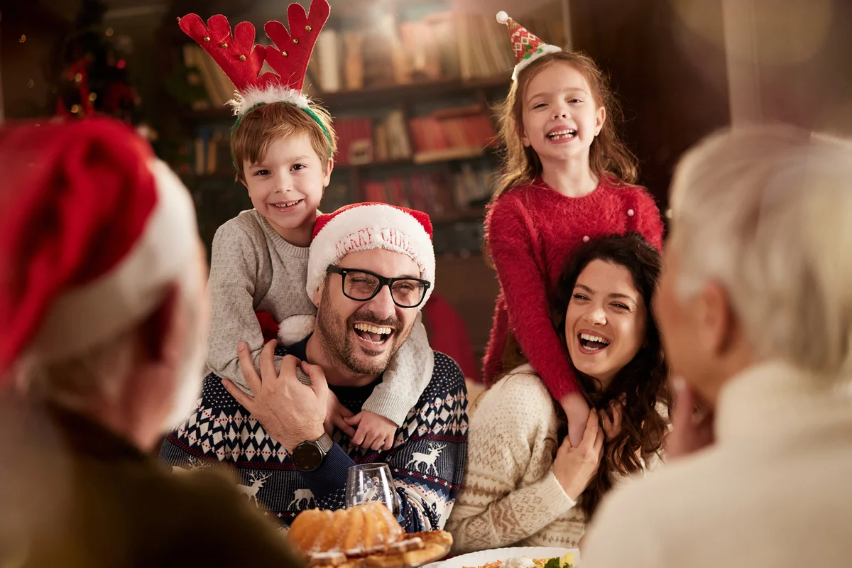 Cheerful family talking on Christmas eve in dining room