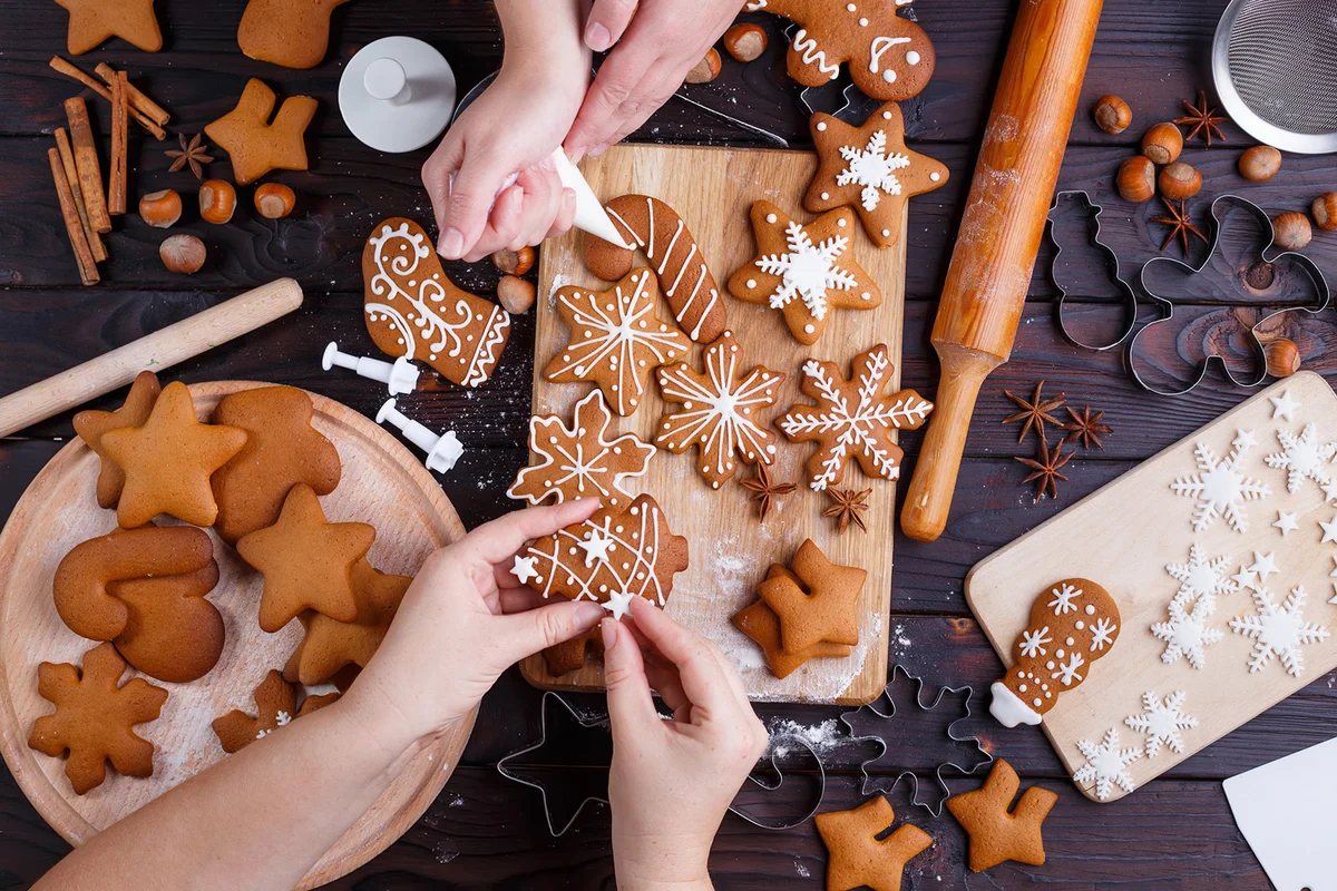 Friends decorating freshly baked cookies