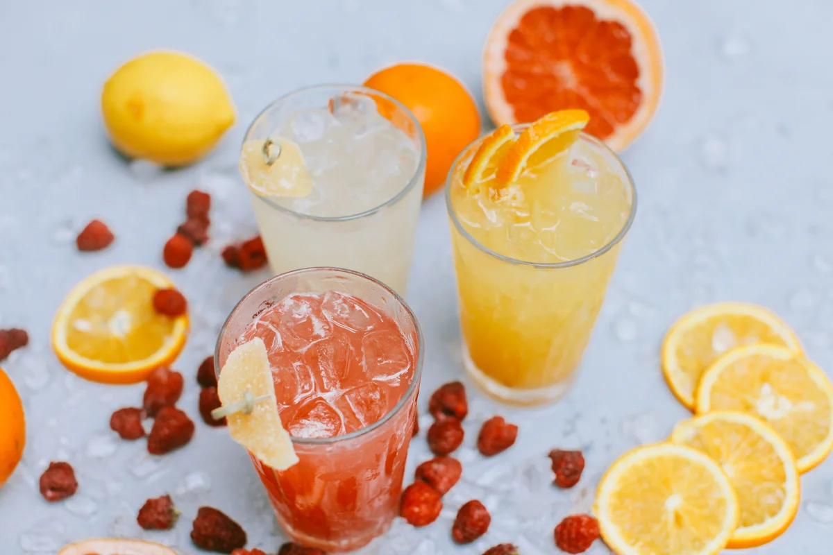 Close-up of orange slices with drink on table