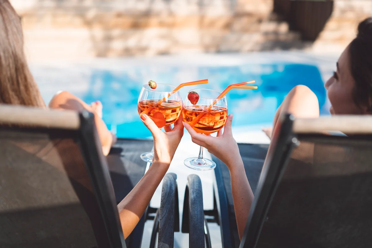 Women sitting on lounge chairs with drinks