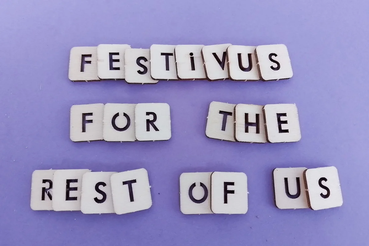 Festivus for the rest of us message on wood blocks on a purple background