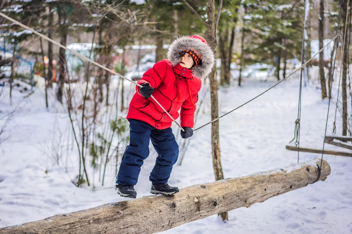 Boy climbing adventure on a winter day