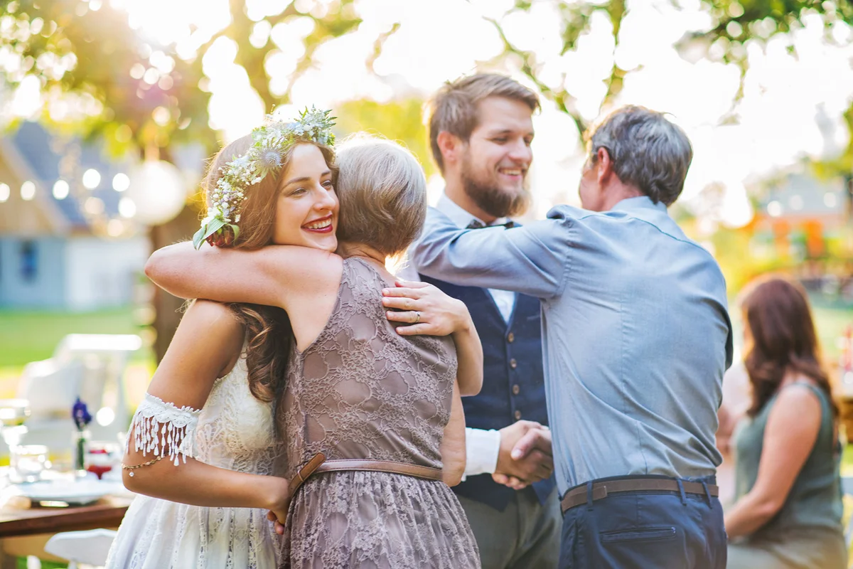 Guests congratulating happy bride and groom at wedding reception