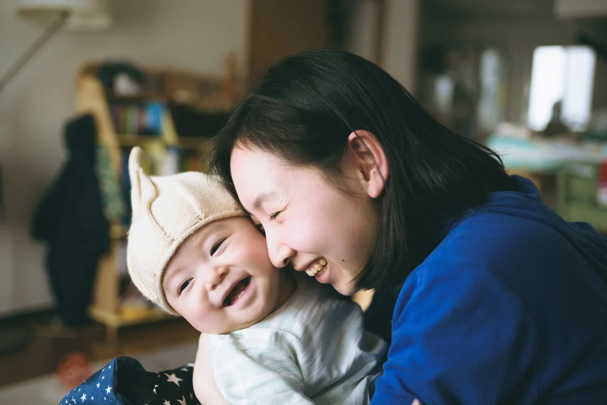 A smiling parent and child